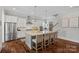 Beautiful kitchen featuring stainless steel appliances, a center island with seating, and sleek white cabinets at 309 Catawba Ave, Davidson, NC 28036