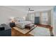 Bright main bedroom with hardwood floors, an area rug, and two windows allowing natural light at 309 Catawba Ave, Davidson, NC 28036