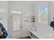 Bright mudroom featuring shiplap walls, a storage bench, a window with shutters, and access to the outdoors at 309 Catawba Ave, Davidson, NC 28036