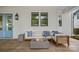 Relaxing covered outdoor patio with a cozy fire pit and comfortable seating area at 309 Catawba Ave, Davidson, NC 28036