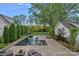Inviting in-ground pool with patio seating and lush landscaping provides a private outdoor retreat at 309 Catawba Ave, Davidson, NC 28036