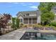 Backyard featuring a dark rectangular pool, patio seating, and manicured landscaping create a private escape at 309 Catawba Ave, Davidson, NC 28036