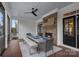 Screened-in porch dining area features a fireplace, ceiling fan, and wood table, providing a relaxing space to dine outdoors at 309 Catawba Ave, Davidson, NC 28036