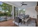 Screened-in porch dining area features a wood table and a ceiling fan, providing a relaxing space to dine outdoors at 309 Catawba Ave, Davidson, NC 28036