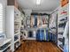 Walk-in closet with custom shelving, hanging rods, and wood flooring for organization at 309 Catawba Ave, Davidson, NC 28036
