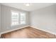 Bright bedroom with dual windows and luxury vinyl plank flooring at 320 Evans Nw St, Concord, NC 28027