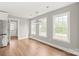 Open-concept dining room featuring large windows and hardwood floors at 320 Evans Nw St, Concord, NC 28027