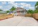 Beautiful home featuring a concrete driveway, a fenced yard, and professional landscaping at 320 Evans Nw St, Concord, NC 28027