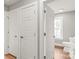 Hallway featuring luxury vinyl plank flooring, doors, and bathroom at 320 Evans Nw St, Concord, NC 28027
