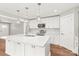 Bright kitchen featuring a large island, modern stainless steel appliances, and elegant pendant lighting at 320 Evans Nw St, Concord, NC 28027