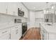 Modern kitchen with stainless steel appliances, white cabinets, marble backsplash, and an island at 320 Evans Nw St, Concord, NC 28027
