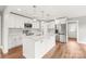 Modern kitchen featuring white cabinets, stainless steel appliances, and a stylish center island at 320 Evans Nw St, Concord, NC 28027