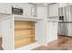 Kitchen island with cabinets open, showcasing the storage space, alongside modern appliances and hardwood floors at 320 Evans Nw St, Concord, NC 28027