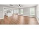 Spacious open-concept living area with hardwood floors and abundant natural light from large windows at 320 Evans Nw St, Concord, NC 28027
