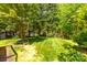 Mature trees and green grass in the shady backyard, creating a peaceful outdoor retreat at 3200 Tallia Ct, Charlotte, NC 28269