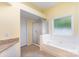 Bright bathroom featuring a soaking tub, separate shower and a neutral color scheme at 3200 Tallia Ct, Charlotte, NC 28269