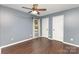 Neutral bedroom includes a ceiling fan, hardwood floors, window with curtains and two doors at 3200 Tallia Ct, Charlotte, NC 28269