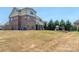 Large backyard features a custom playground and offers ample space for outdoor activities at 323 Cheshire Ln, Fort Mill, SC 29707