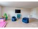 Versatile basement space perfect for recreation or relaxation, featuring comfortable seating and a TV at 323 Cheshire Ln, Fort Mill, SC 29707