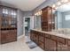 Bathroom showcasing dual sinks, granite counters, and ample cabinet space at 323 Cheshire Ln, Fort Mill, SC 29707