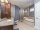 Bathroom with tile flooring, tiled shower, and granite countertops and a soaking tub at 323 Cheshire Ln, Fort Mill, SC 29707
