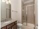 A bathroom with a glass enclosed shower, granite topped vanity and toilet at 323 Cheshire Ln, Fort Mill, SC 29707