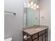 Bathroom featuring granite countertops, wood cabinets, and decorative lighting fixtures at 323 Cheshire Ln, Fort Mill, SC 29707
