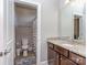 Well-lit bathroom with granite countertop, wood vanity, and a view into the toilet and shower area at 323 Cheshire Ln, Fort Mill, SC 29707