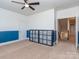 Spacious bedroom with blue-and-white walls, a ceiling fan, and built-in shelving at 323 Cheshire Ln, Fort Mill, SC 29707