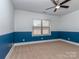 Well-lit bedroom with blue-and-white walls, a ceiling fan, and a bright window at 323 Cheshire Ln, Fort Mill, SC 29707