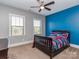 Vibrant bedroom with stylish bedding, two windows for natural light, and a contrasting accent wall at 323 Cheshire Ln, Fort Mill, SC 29707