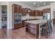Kitchen island with granite countertop and seating, stainless appliances and walk-in pantry for optimal storage at 323 Cheshire Ln, Fort Mill, SC 29707