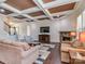 Inviting living room boasts coffered ceilings, a stone fireplace, hardwood floors and comfortable seating at 323 Cheshire Ln, Fort Mill, SC 29707