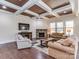 Spacious living room with coffered ceiling, stone fireplace and hardwood floors at 323 Cheshire Ln, Fort Mill, SC 29707