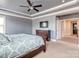 Spacious main bedroom featuring tray ceilings, a ceiling fan, and a television at 323 Cheshire Ln, Fort Mill, SC 29707