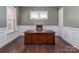 Home office space with dark wood floors, white wainscoting, and a large wooden desk at 323 Cheshire Ln, Fort Mill, SC 29707