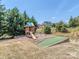 Enjoy Gathering time on the backyard playground with slide, swing set, and putting green at 323 Cheshire Ln, Fort Mill, SC 29707