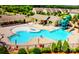 Aerial view of sparkling community pool with waterslides and splash pad for Gathering fun at 323 Cheshire Ln, Fort Mill, SC 29707
