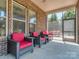Relax on the screened porch with comfortable wicker seating and a serene view at 323 Cheshire Ln, Fort Mill, SC 29707