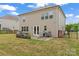 View of backyard features a patio with grill, fenced yard, and the home's exterior at 341 Pleasant Hill Se Dr, Concord, NC 28025