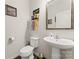 Charming half-bathroom featuring decorative elements, a pedestal sink, and a toilet at 341 Pleasant Hill Se Dr, Concord, NC 28025