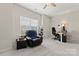 Bright bonus room offers plush carpet, a comfy chair, a functional desk, and ample natural light at 341 Pleasant Hill Se Dr, Concord, NC 28025