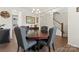 Elegant dining room featuring a dark wood table, gray upholstered chairs, and stylish chandelier at 341 Pleasant Hill Se Dr, Concord, NC 28025