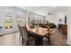 Open-concept dining area flowing into a spacious living room with fireplace and ample natural light at 341 Pleasant Hill Se Dr, Concord, NC 28025
