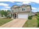 Inviting two-story home with stone accents, a covered front porch, and an attached two-car garage at 341 Pleasant Hill Se Dr, Concord, NC 28025