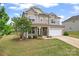Beautiful two-story home with manicured lawn, stone accents, covered porch, and an attached garage at 341 Pleasant Hill Se Dr, Concord, NC 28025