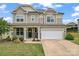 Charming two-story home featuring a covered porch, attached two-car garage, and landscaped front yard at 341 Pleasant Hill Se Dr, Concord, NC 28025