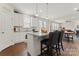 Beautiful kitchen featuring white cabinets, a center island with seating, and an open layout to the living room at 341 Pleasant Hill Se Dr, Concord, NC 28025