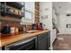 Cozy kitchen coffee bar area featuring a wood countertop, wine fridge, and ample shelving at 341 Pleasant Hill Se Dr, Concord, NC 28025