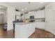Bright kitchen features white cabinets, a center island with granite countertop, and stainless steel appliances at 341 Pleasant Hill Se Dr, Concord, NC 28025